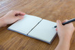 © jannoon028 - Hands with pencil and book on wood table