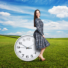 Wall Mural - woman sitting on the big clock