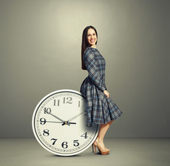 young woman sitting on a clock