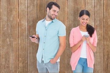 Poster - Composite image of happy couple sending text messages
