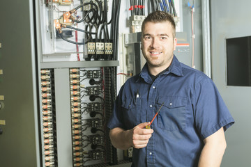 Portrait of an happy worker in a factory