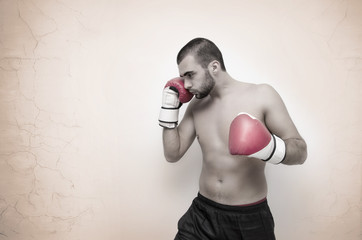 Young boxer contrasty artistic image on grunge background