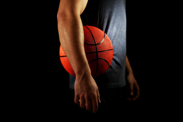 Canvas Print - Basketball player holding ball, on dark background