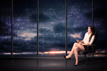 Wall Mural - Businesswoman holding tablet in office room with graph charts on