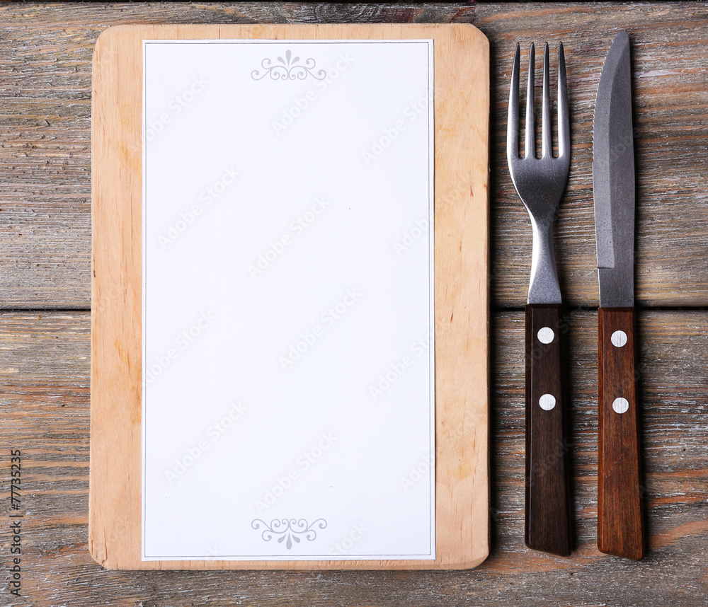 Cutting board with menu sheet of paper