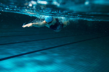 Female Swimmer At The Swimming Pool.Underwater Photo.