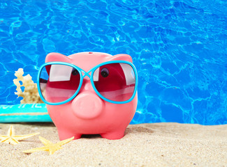 Poster - Piggy bank on beach background