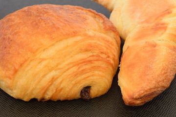 Two fresh croissants.on a black background.