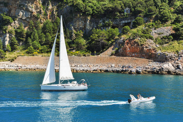 Boats sailing near the coastline