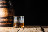 Fototapeta Uliczki - Strong alcohol on a wooden table and barrel