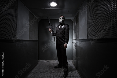 Male with the rifle and gas mask in an old elevator Poster