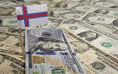 Flag of Faroe Islands sticking in various american banknotes.(se