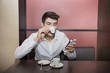© theartofphoto - Young Man Drinking Coffee While Looking at Phone