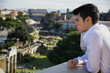 © theartofphoto - Serious Man on Terrace Looking at Outdoor View in Rome, Italy
