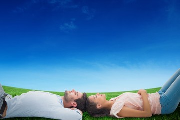 Poster - Composite image of attractive young couple lying down