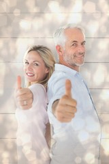 Poster - Composite image of smiling couple showing thumbs up together