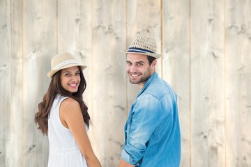 Poster - Happy hipster couple holding hands and smiling at camera