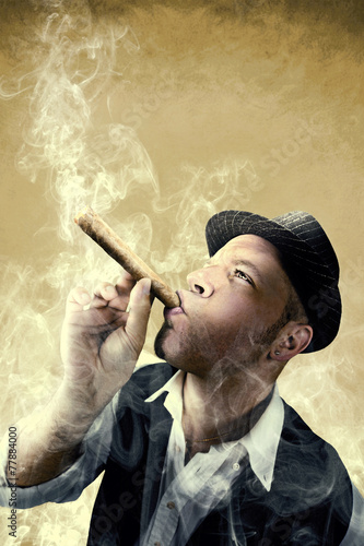 Fototapeta na wymiar man smoking a big cigar surrounded by smoke