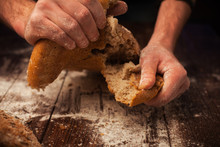 Baker Hands With Fresh Bread On Table