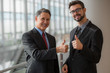 Two businessmen giving a thumbs-up
