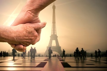 composite image of elderly couple holding hands