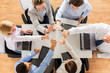 © Syda Productions - close up of business team showing high five