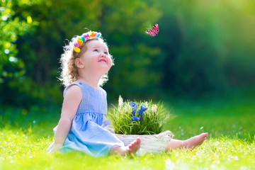 Wall Mural - Little girl playing with a butterfly