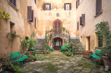 Canvas Print - The old Italian town in the colors of spring in Tuscany 