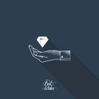 Diamond in hand on dark blue background with long shadow.