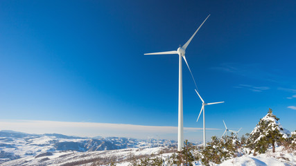 Typical windmill or aerogenerator of aeolian energy on snowy lan