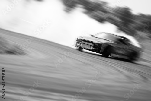 Fotografía Very fast driving, motion blur drift black and white