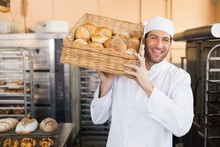 Baker Holding Basket Of Bread