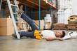 © WavebreakmediaMicro - Worker lying on the floor in warehouse