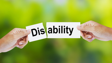 Businessman tearing the word Disability for Ability
