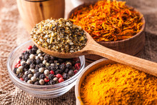 Set Dry Spices In A Wooden And Glass Bowls Close-up