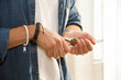 © theartofphoto - Hands of young man cracking nut with nutcracker