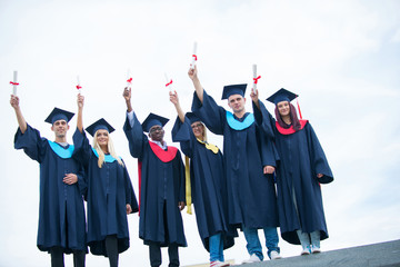 group of graduates celebrating outdoors