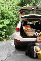 Wall Mural - Suitcases and bags in trunk of car ready to depart for holidays