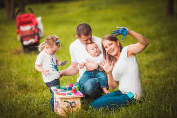 Happy family with nesting box and paints