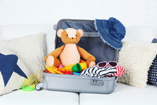 Suitcase Packed With Clothes And Child Toys