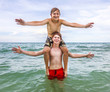 © travelview - boys having fun in the beautiful clear sea