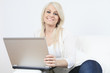 © Louis-Paul Photo - young beautiful woman using a laptop computer at home
