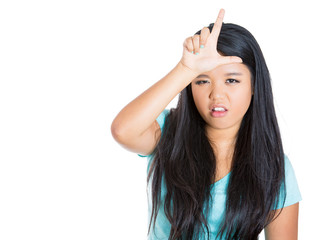 Young woman showing loser sing on white background 