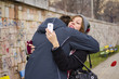 © creativefamily - Boy hugging a girl while she looks at her smartphone