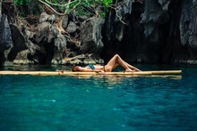 Beautiful Woman Relaxing On Raft In Tropical Lagoon