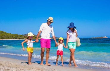 Happy family of four during beach vacation