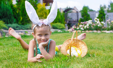 adorable little girl wearing bunny ears holding basket with