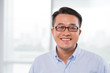 © DragonImages - Smiling Vietnamese man in glasses