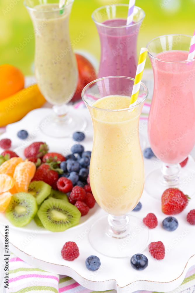 Delicious berry cocktails on table on bright background