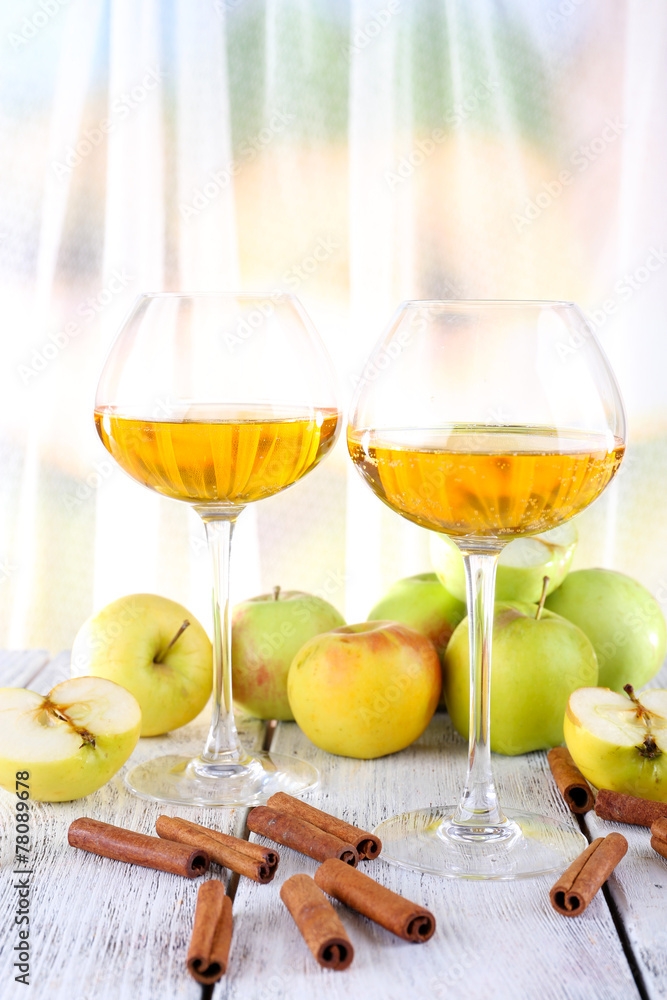 still life with apple cider and fresh apples on wooden table